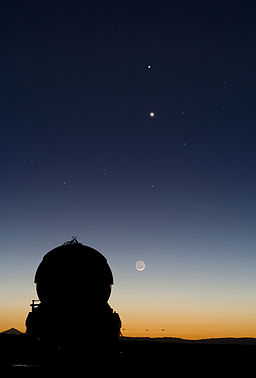 Conjunction of Mercury and Venus, align above the Moon, at the Paranal Observatory.